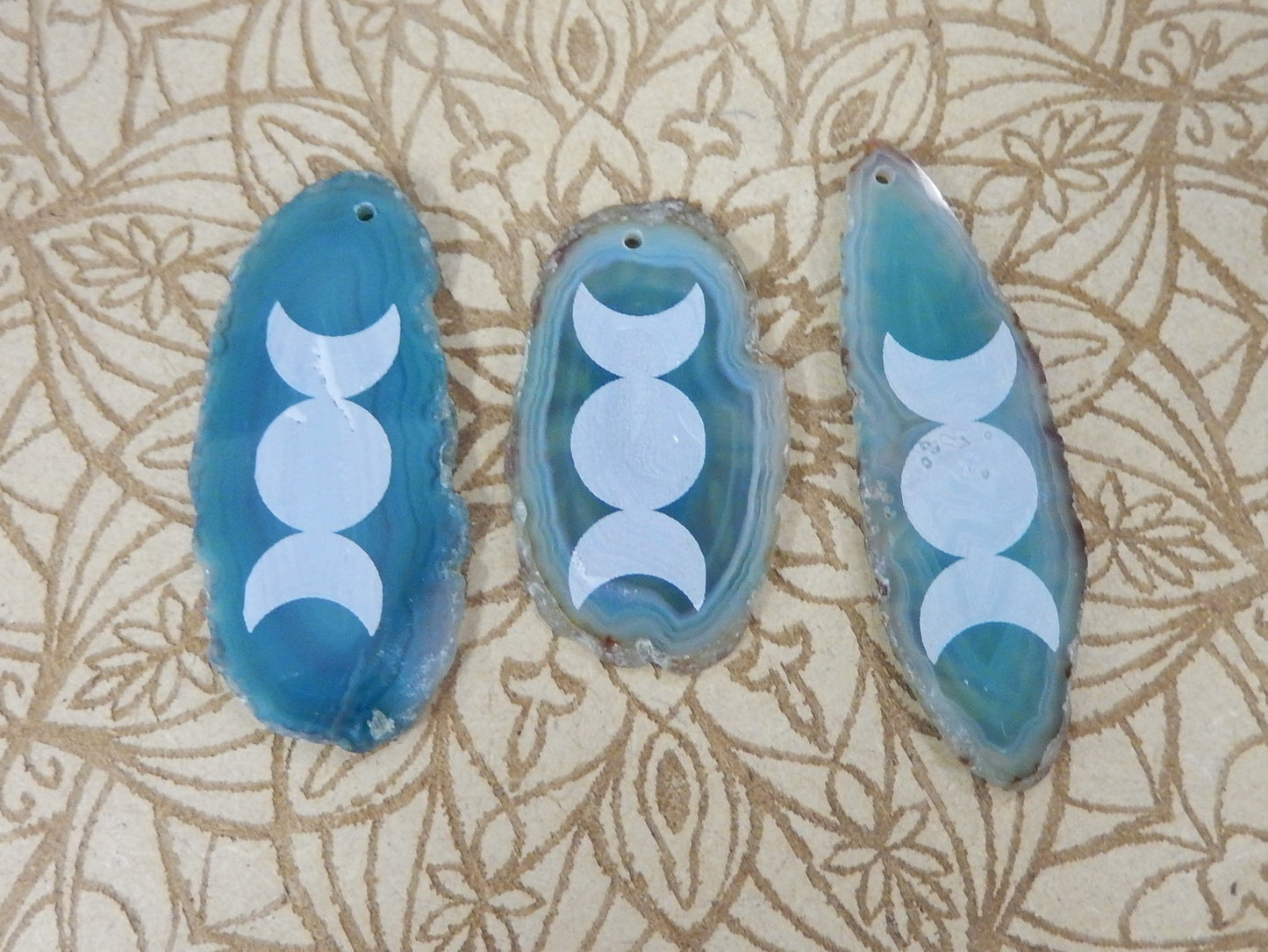 Picture of 3 of our teal agate slice with large moon phase.