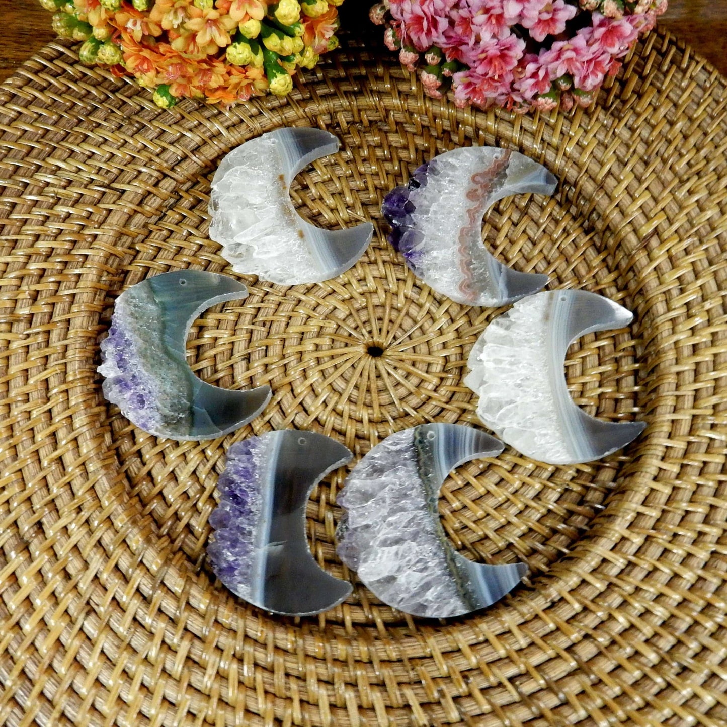 large drilled amethyst half moon with decorations in the background