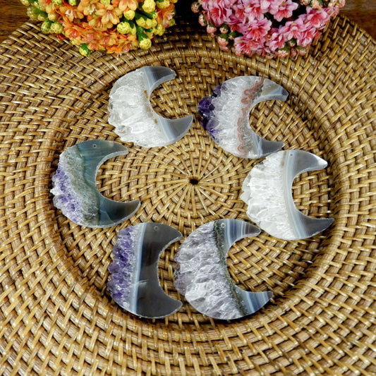 large drilled amethyst half moon with decorations in the background