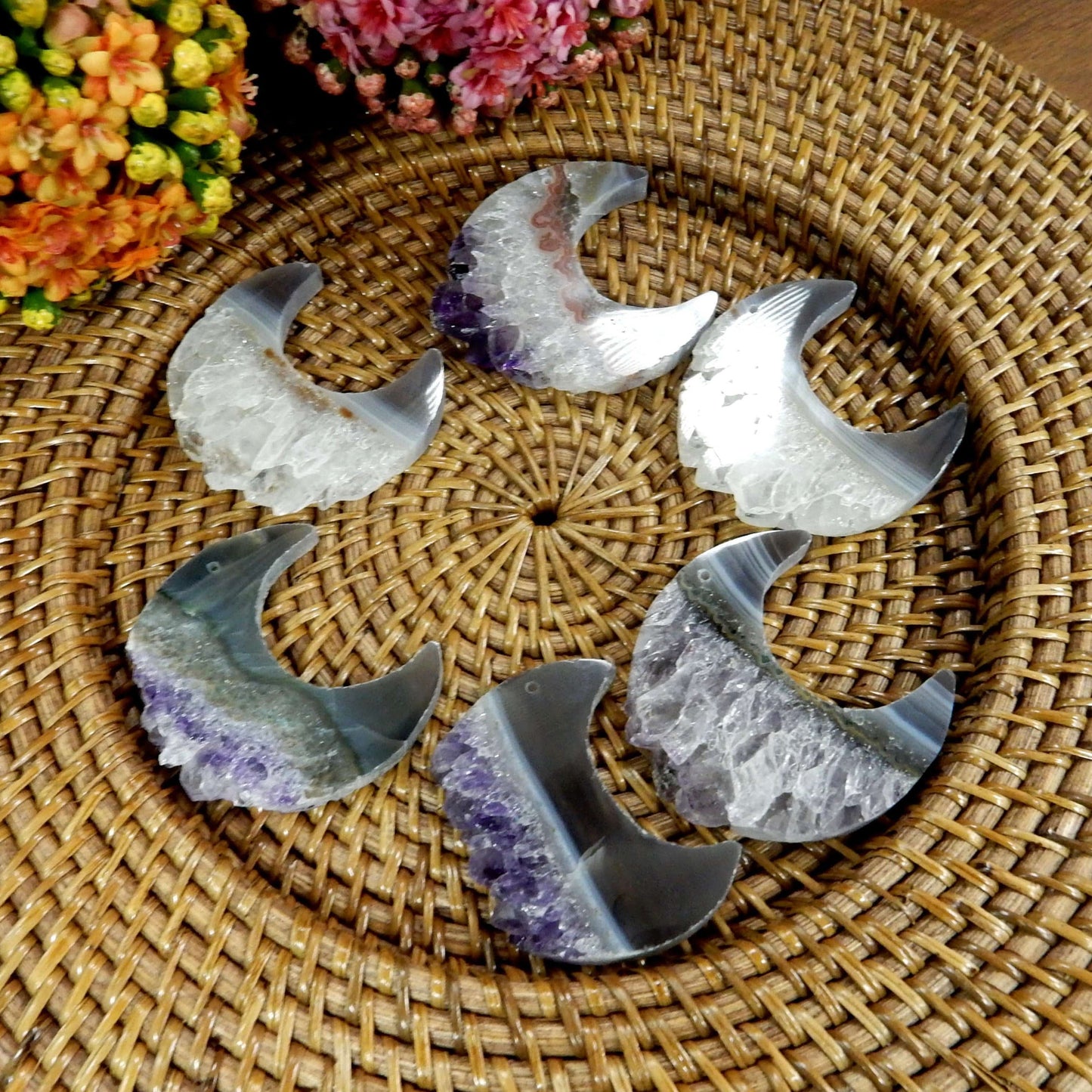 large drilled amethyst half moon with decorations in the background