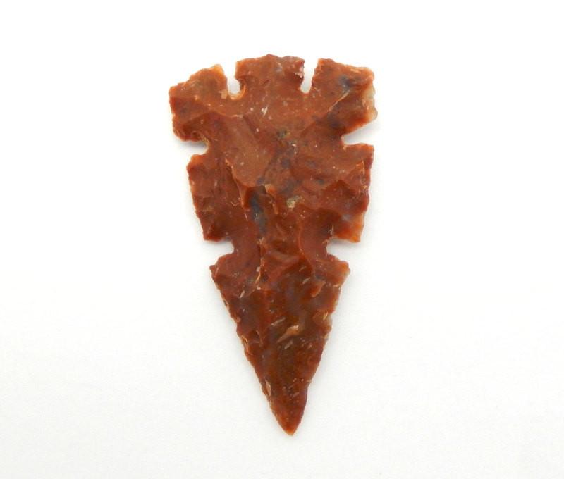 birds eye view of one jasper arrowhead on a white background