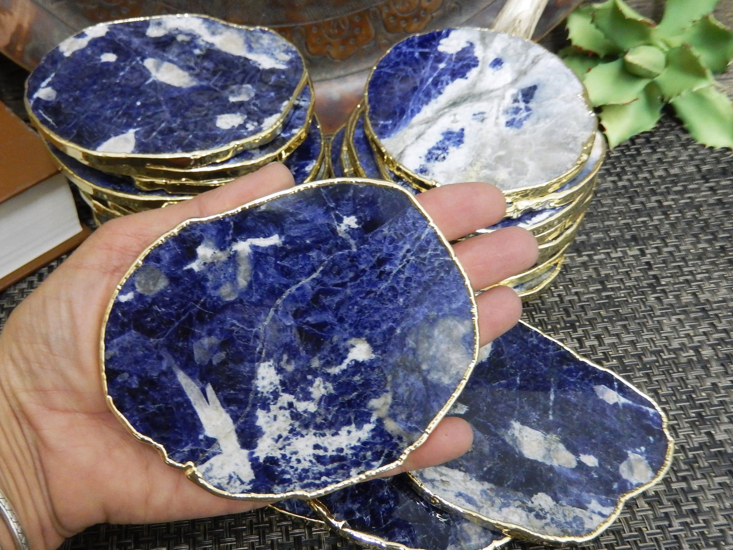 sodalite Stone Slices  stacked up with one in a hand for size reference
