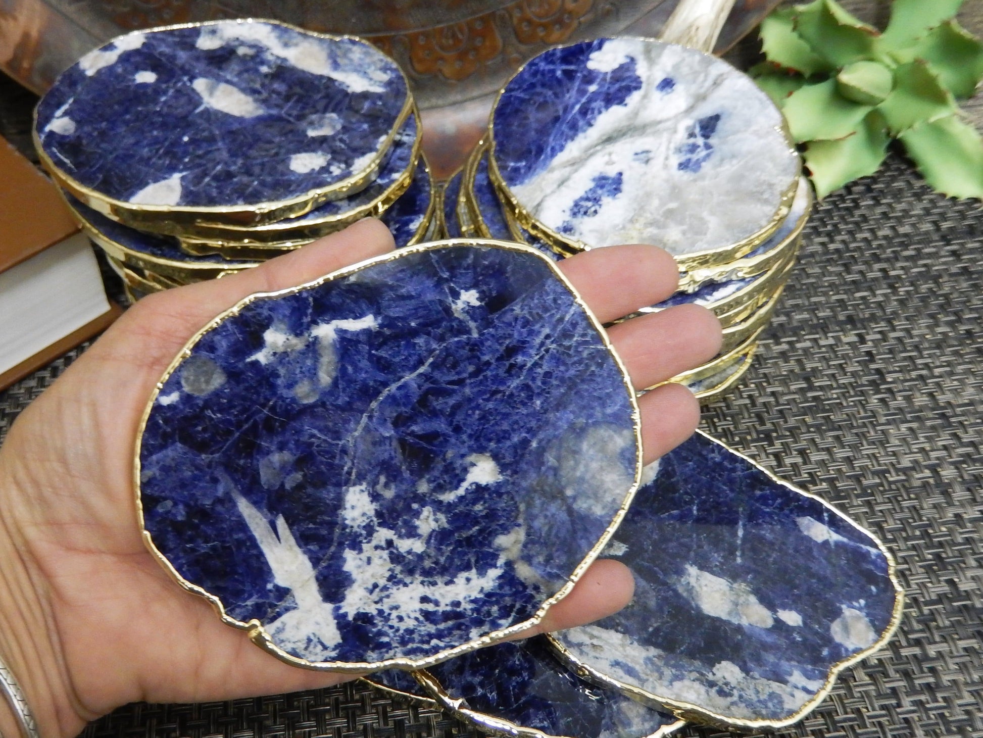 sodalite Stone Slices  stacked up with one in a hand for size reference