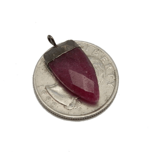 pendant next to a quarter for size reference 