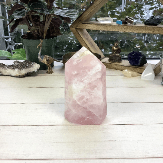 polished rose quartz point displayed as home decor 