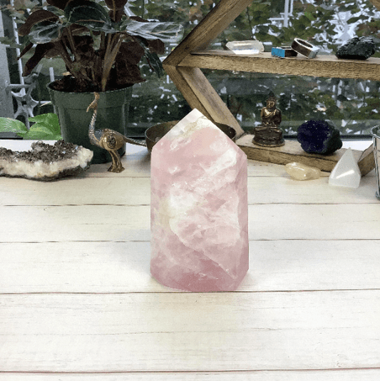 polished rose quartz point displayed as home decor 