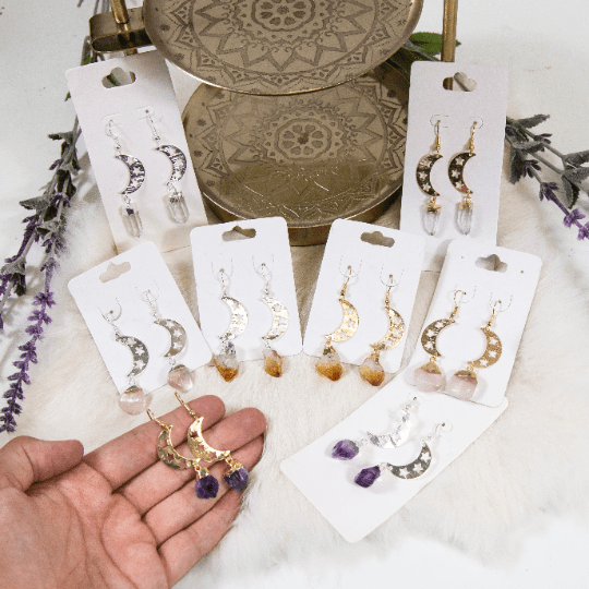 moon gemstone earrings in hand for size reference 