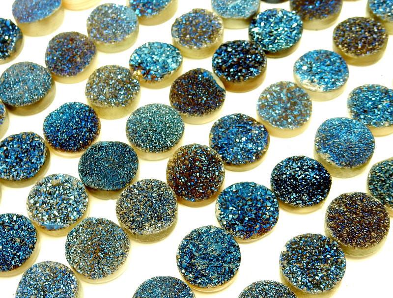 angled shot of  Blue Round Shaped Druzy Cabochons on white background