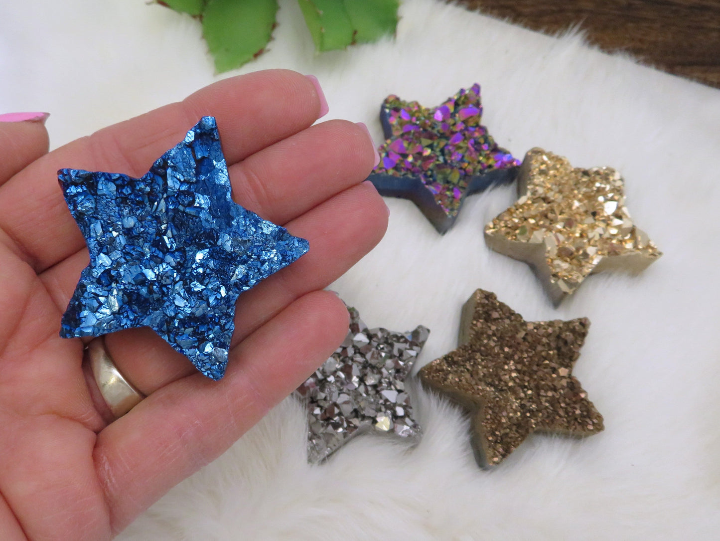 Up close of Blue Titanium Treated Druzy Stars in hand.