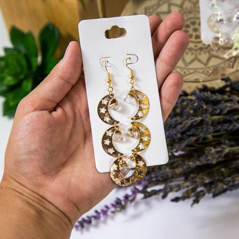 Triple Moon with Gemstones Earrings with Crystal Quartz stone and Gold finish, in a hand for size reference
