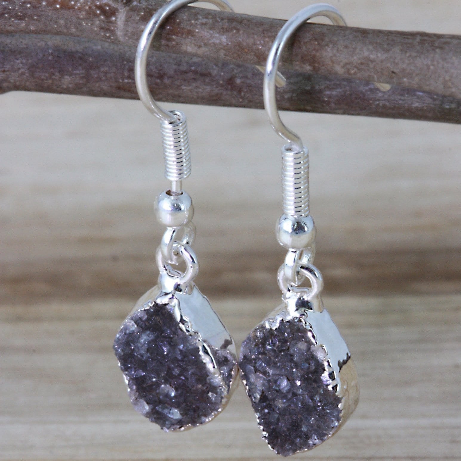 amethsyt marquise earrings on a branch