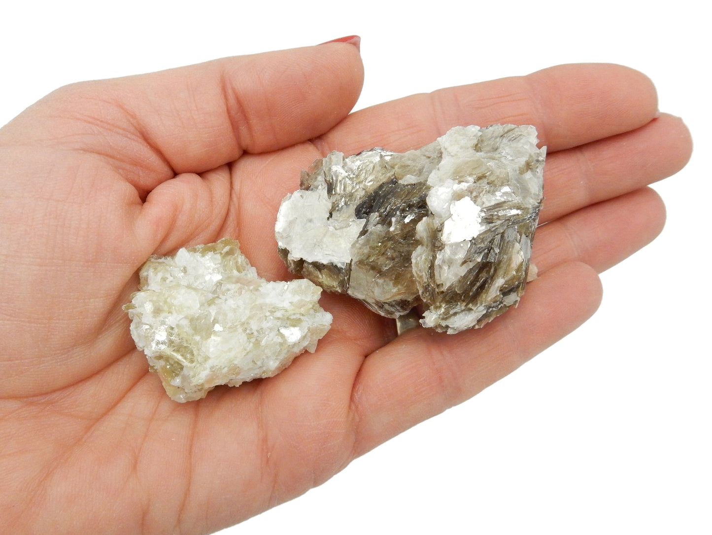 hand holding up star mica clusters on white background