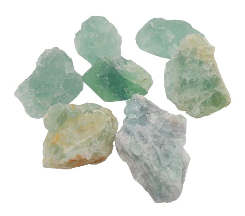 Seven Green Fluorite stones on a white background