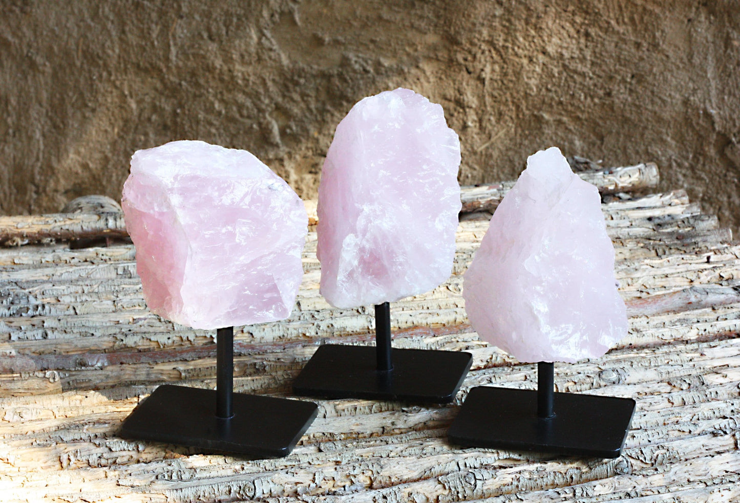3 Rose Quartz on Metal Stands on wood