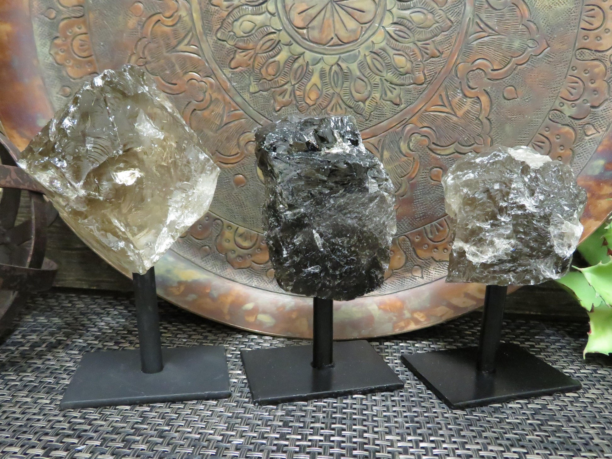 smoky quartz on metal stand with decorations in the background