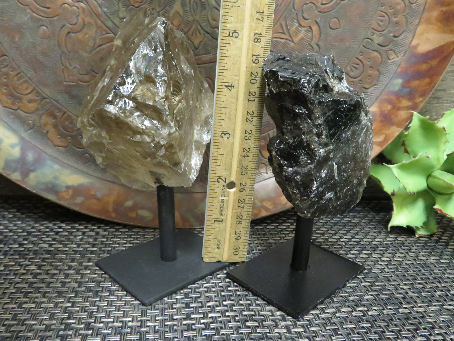 smoky quartz on metal stand with decorations in the background