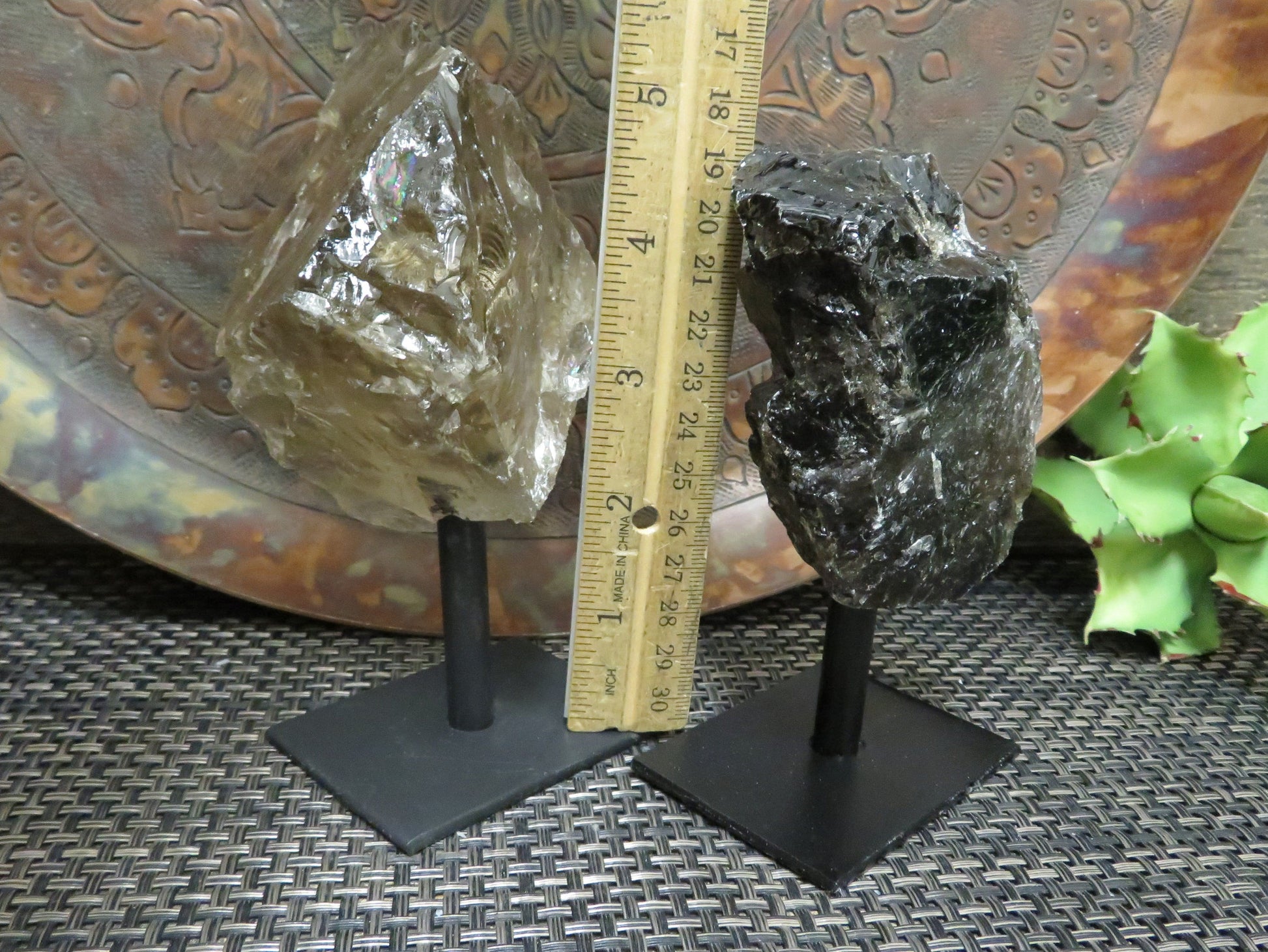 smoky quartz on metal stand with decorations in the background