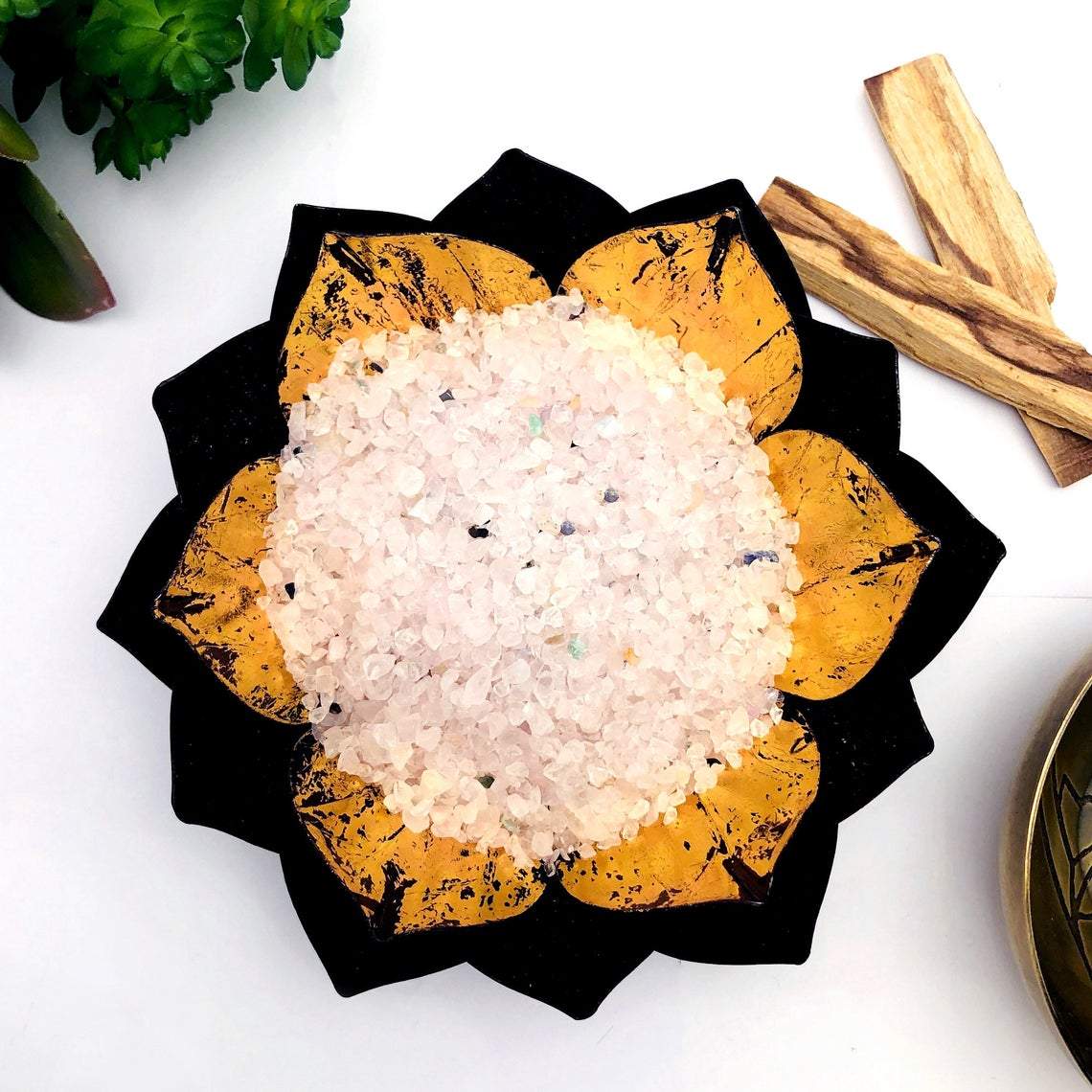 decorative bowl filled with Rose Quartz Tiny Chip Stones and other decorations surrounding it 