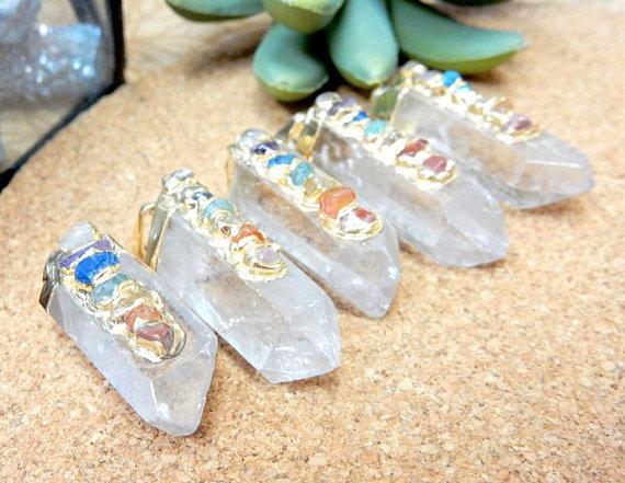 angled shot of Crystal Quartz Point Pendants on brown background
