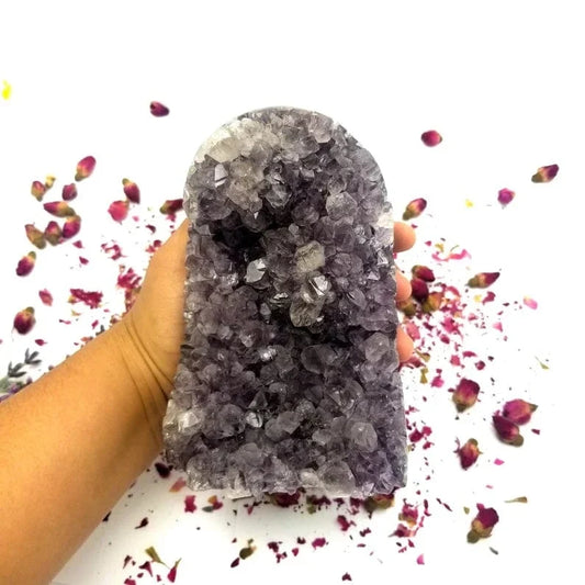 Amethyst Cut Base Cluster in a hand for size reference