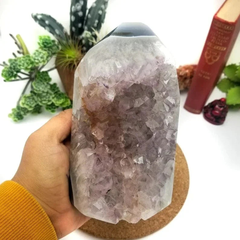 Amethyst Cut Base Cluster in a hand for size reference