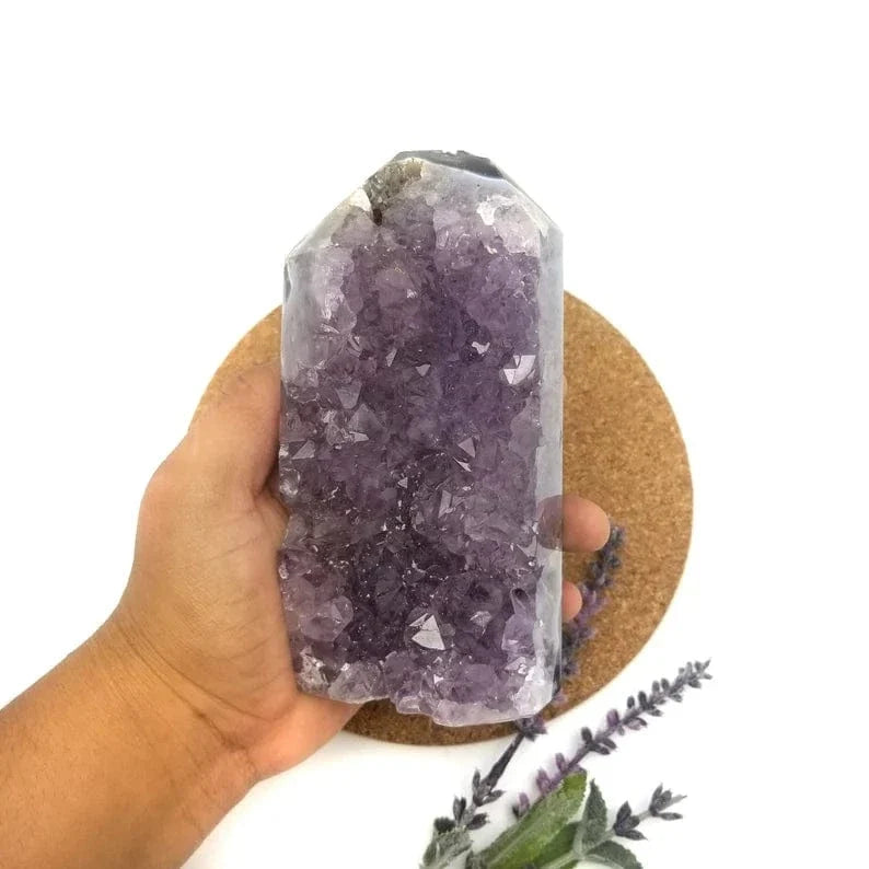 Amethyst Crystal Cut Base in a hand for size reference