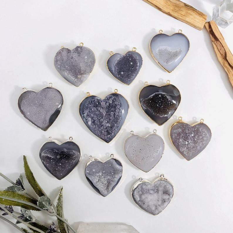 Top view of front facing agate druzy hearts in an alter with a white background.