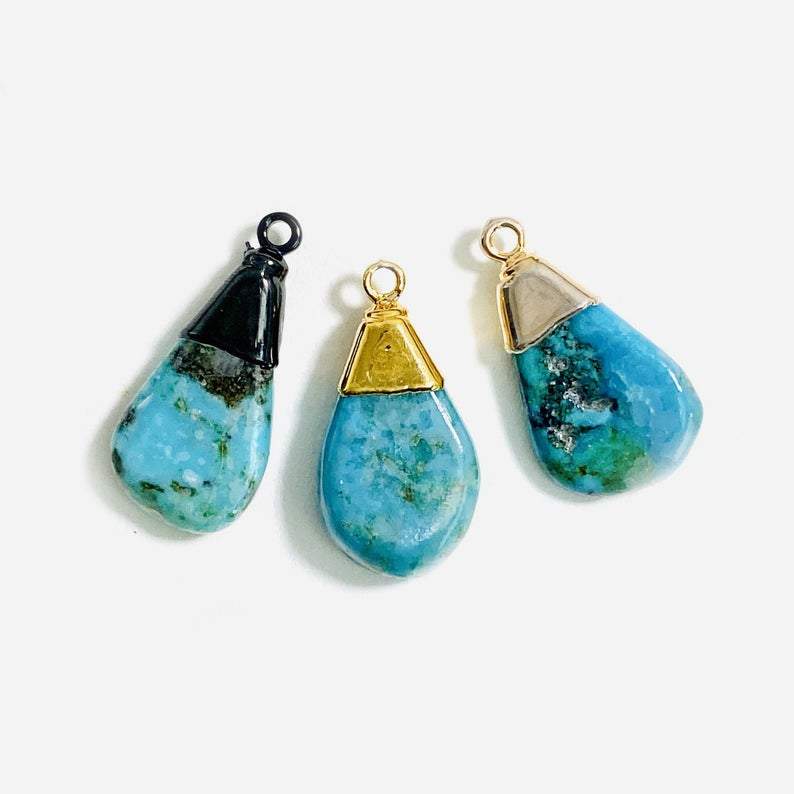 Natural turquoise tear drop pendants.  Pictured in gold plated, silver plated, and black rhodium plated.  They are teardrop shaped and have plating just along the top part.  Small bail, a jumpring would need to be added to make them wearable.