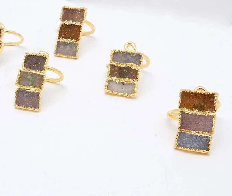 4 Triple Rectangle Druzy with Electroplated 24k Gold Edges on an Adjustable 24k Gold Electroplated Rings showing varying colors of white, tan brown, greys, darks, lavenders