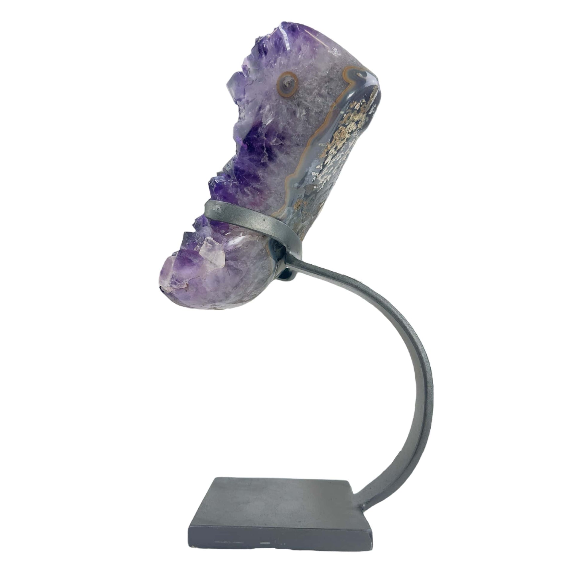 side view of amethyst on stand on white background