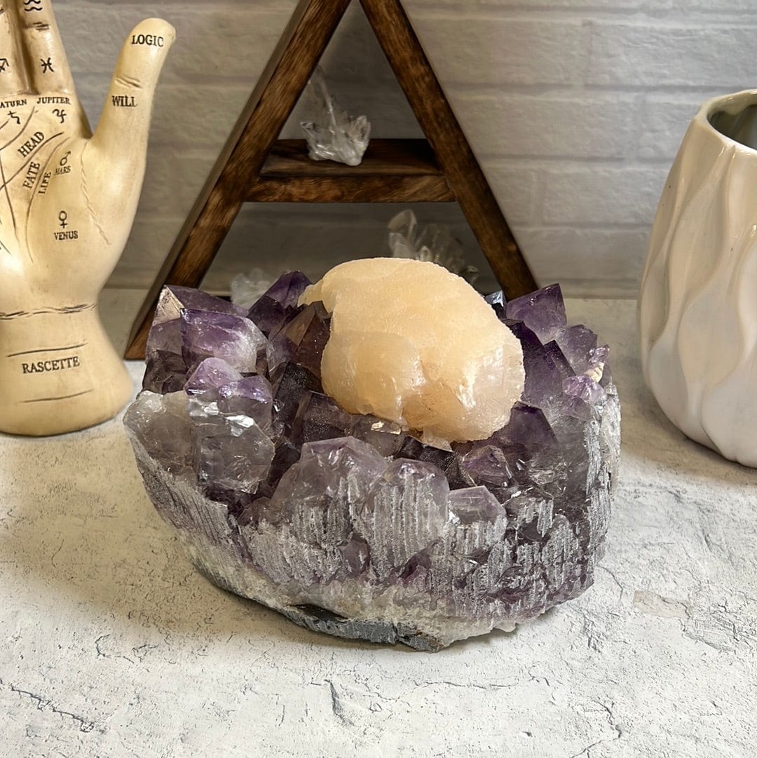 Large high quality purple amethyst cluster with a large cream color calcite formation around the center of it.