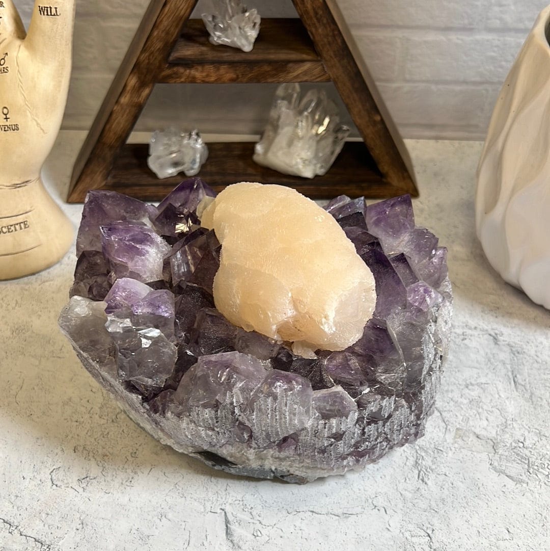 Large high quality purple amethyst cluster with a large cream color calcite formation around the center of it.