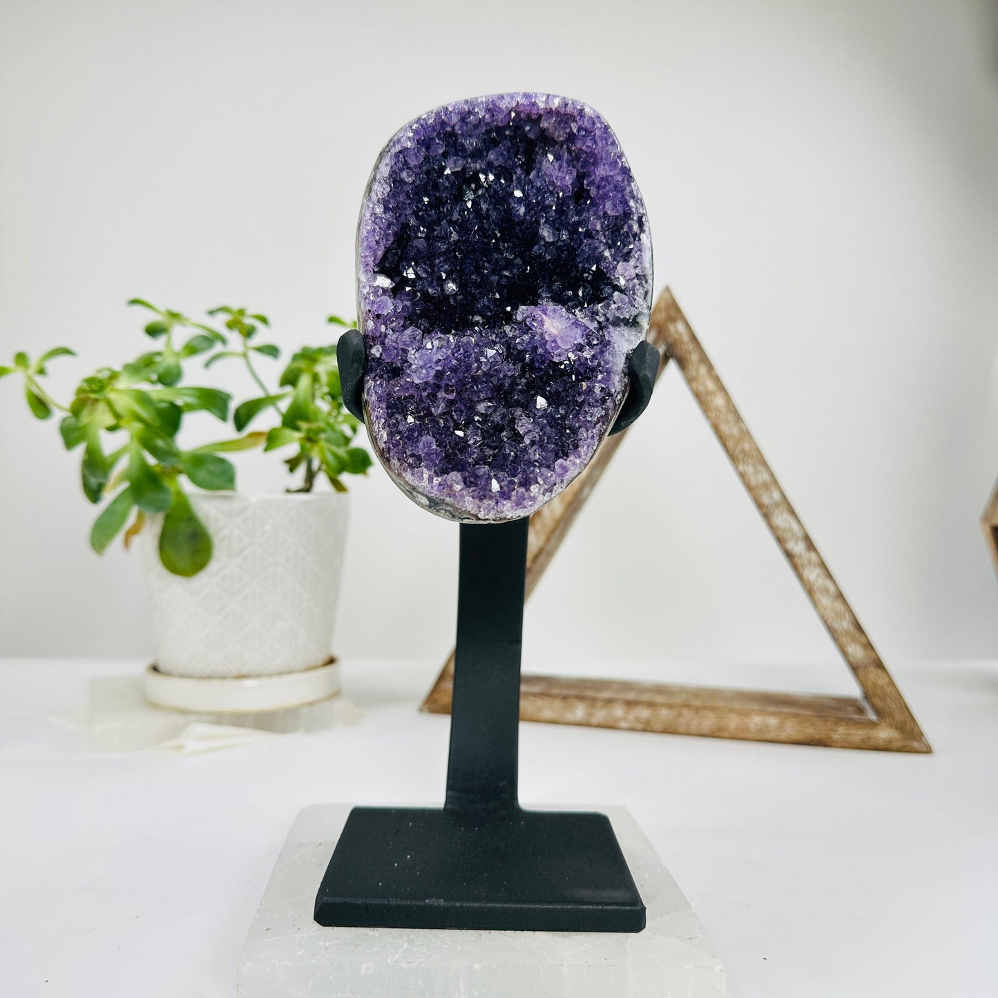 amethyst on metal stand with decorations in the background