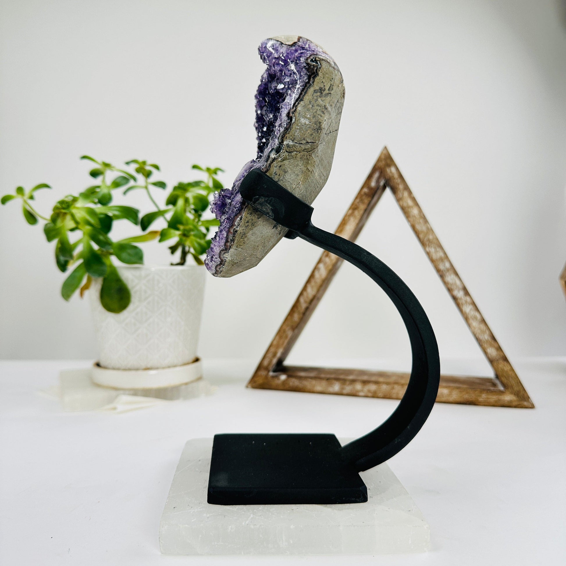 amethyst on metal stand with decorations in the background