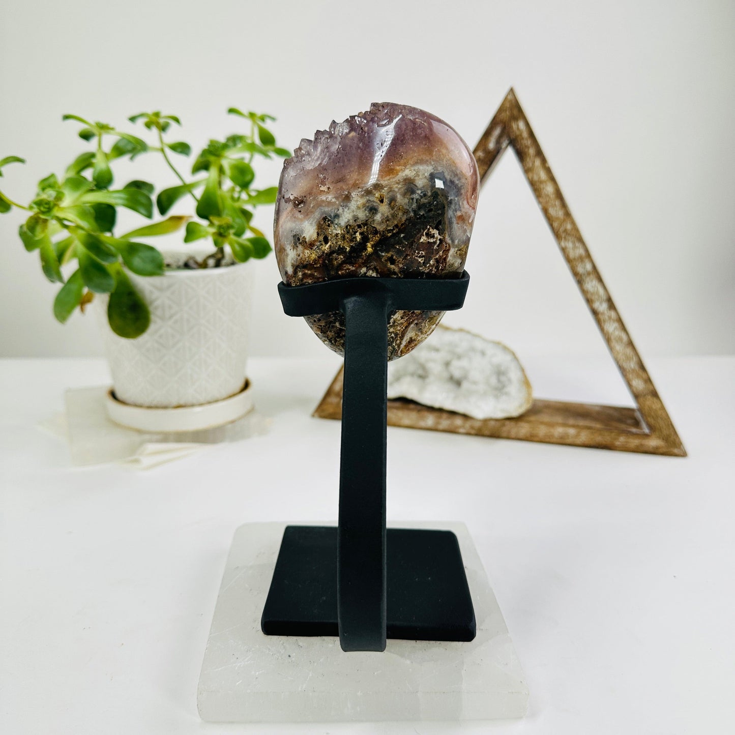 amethyst on metal stand with decorations in the background