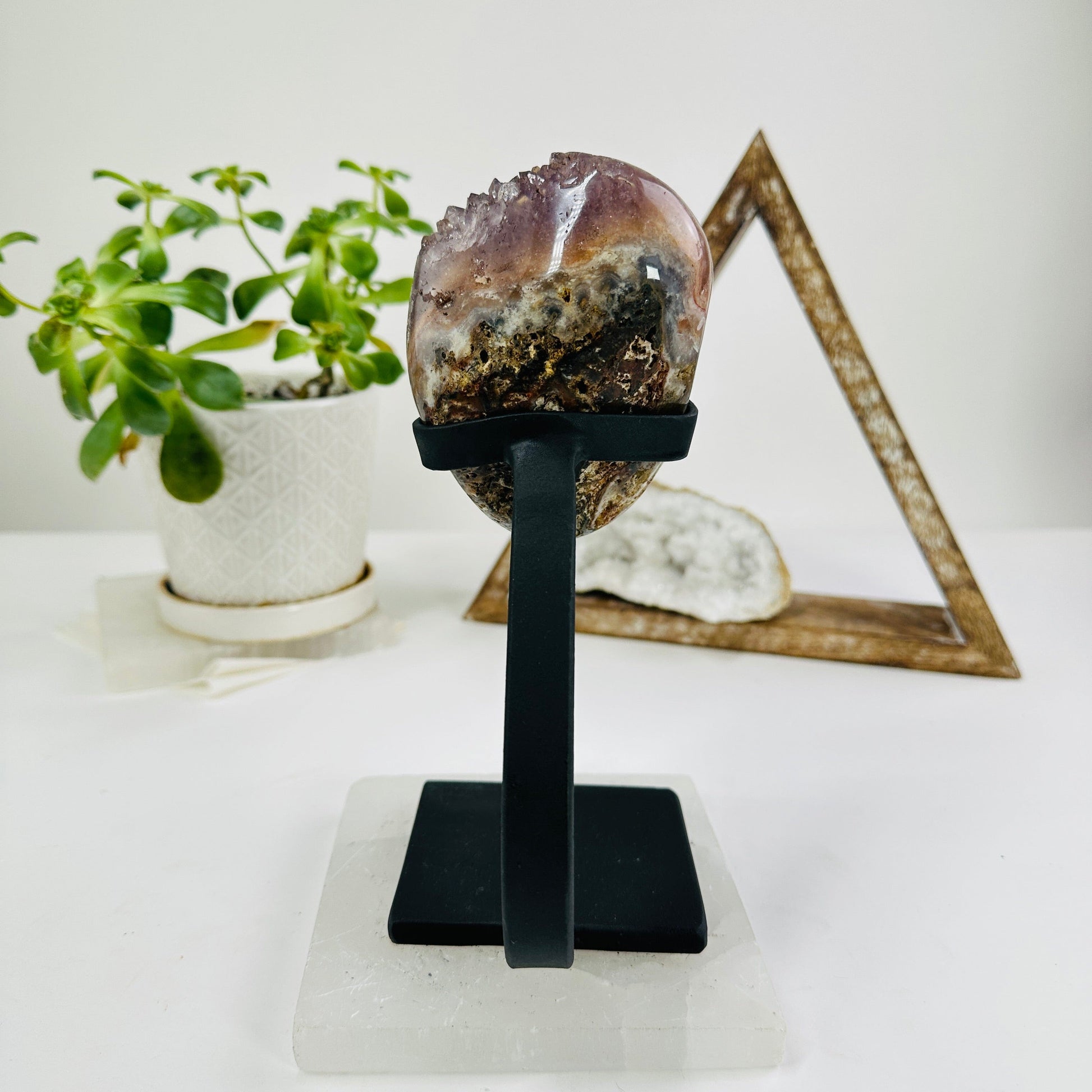 amethyst on metal stand with decorations in the background