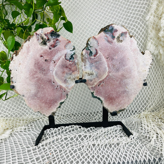 Pink amethyst wings with decorations in the background