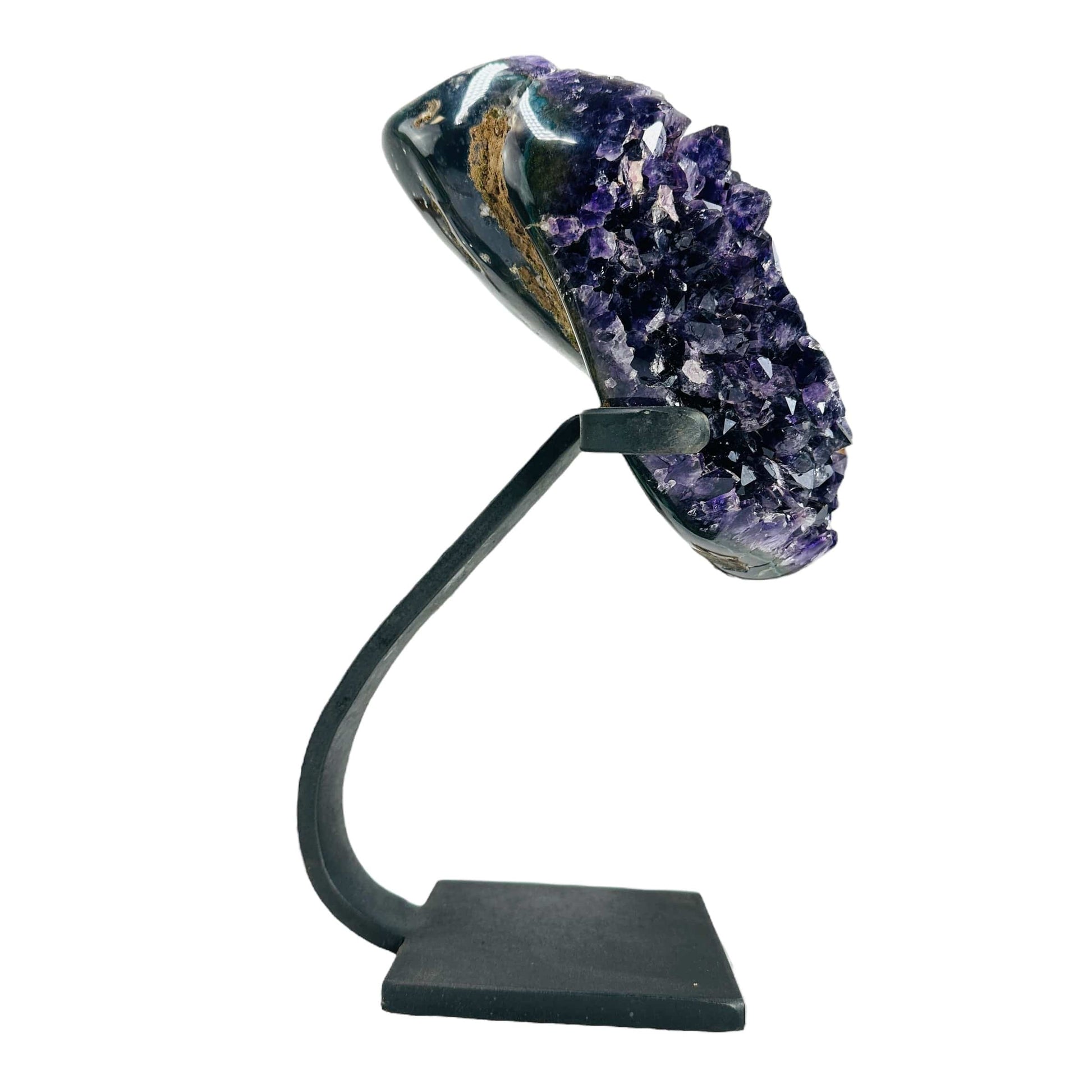 side view of amethyst on stand on white background