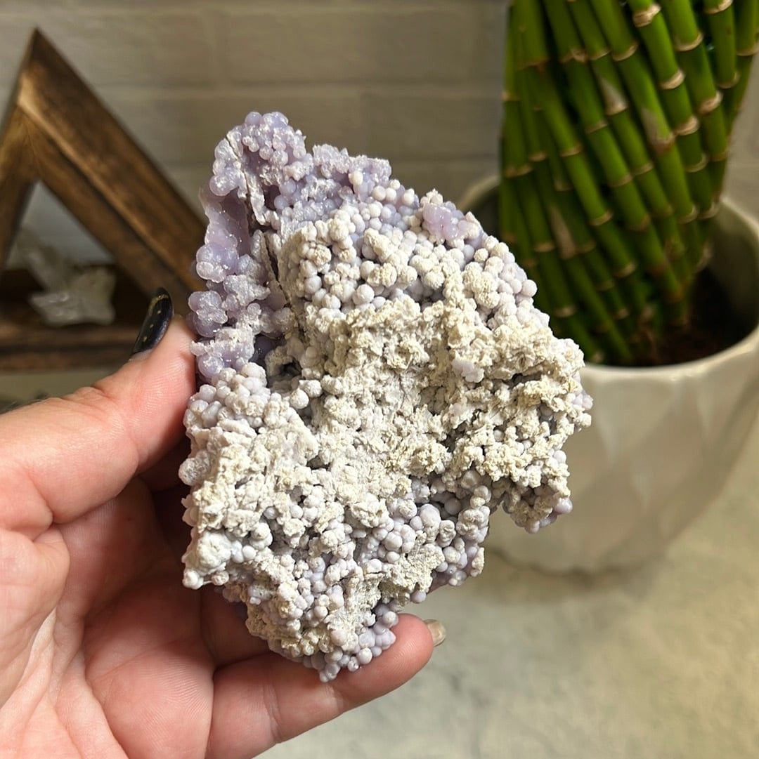 Grape agate formation in a woman's hand.