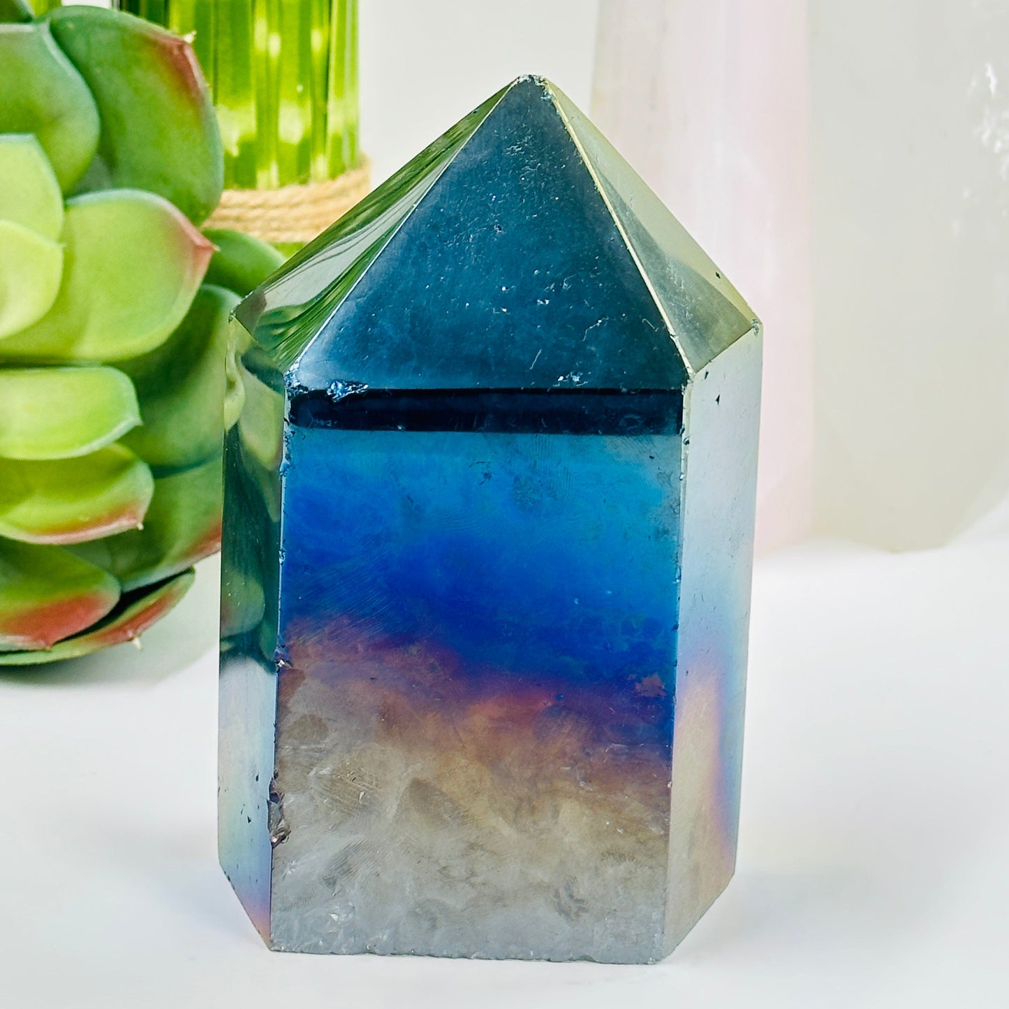 backside of rainbow titanium coated agate point with decorations in the background