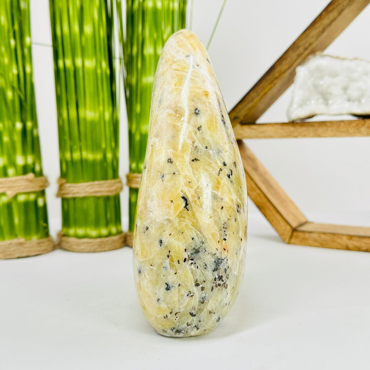 side view of dendrite opal cut base with decorations in the background