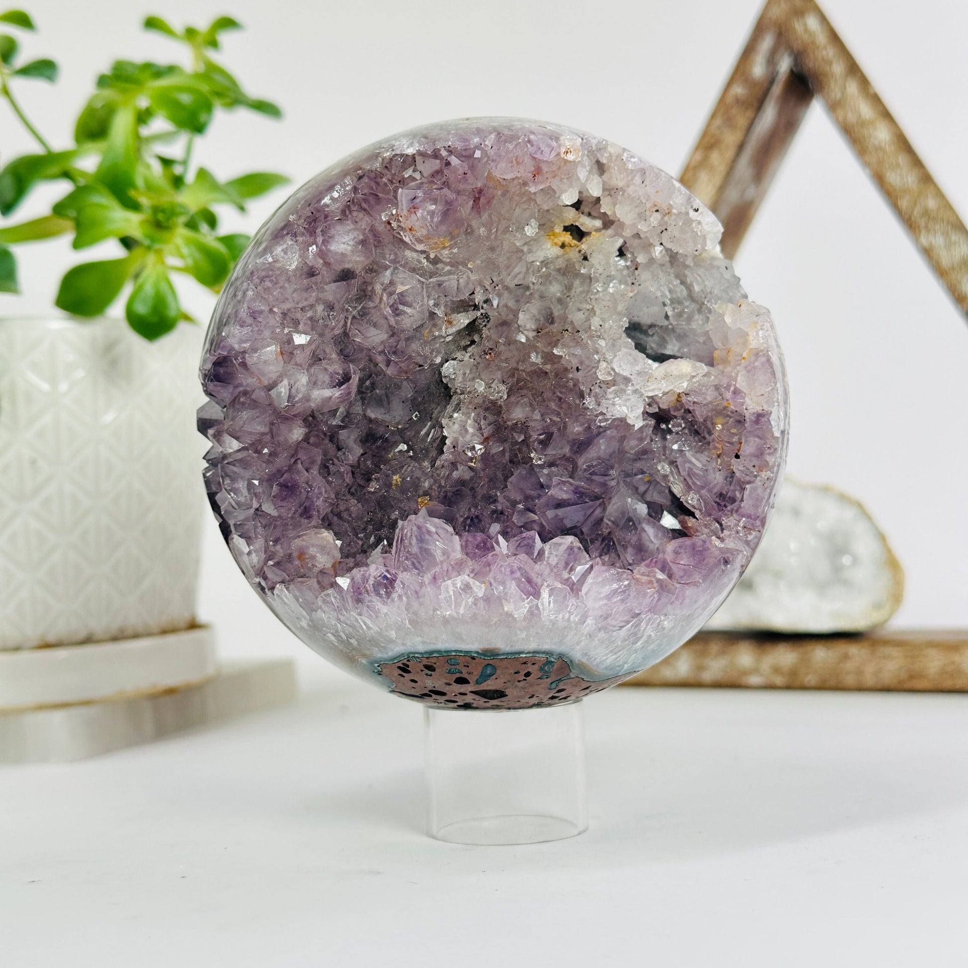 amethyst druzy sphere with decorations in the background