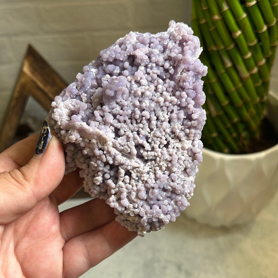 Grape agate formation in a woman's hand.