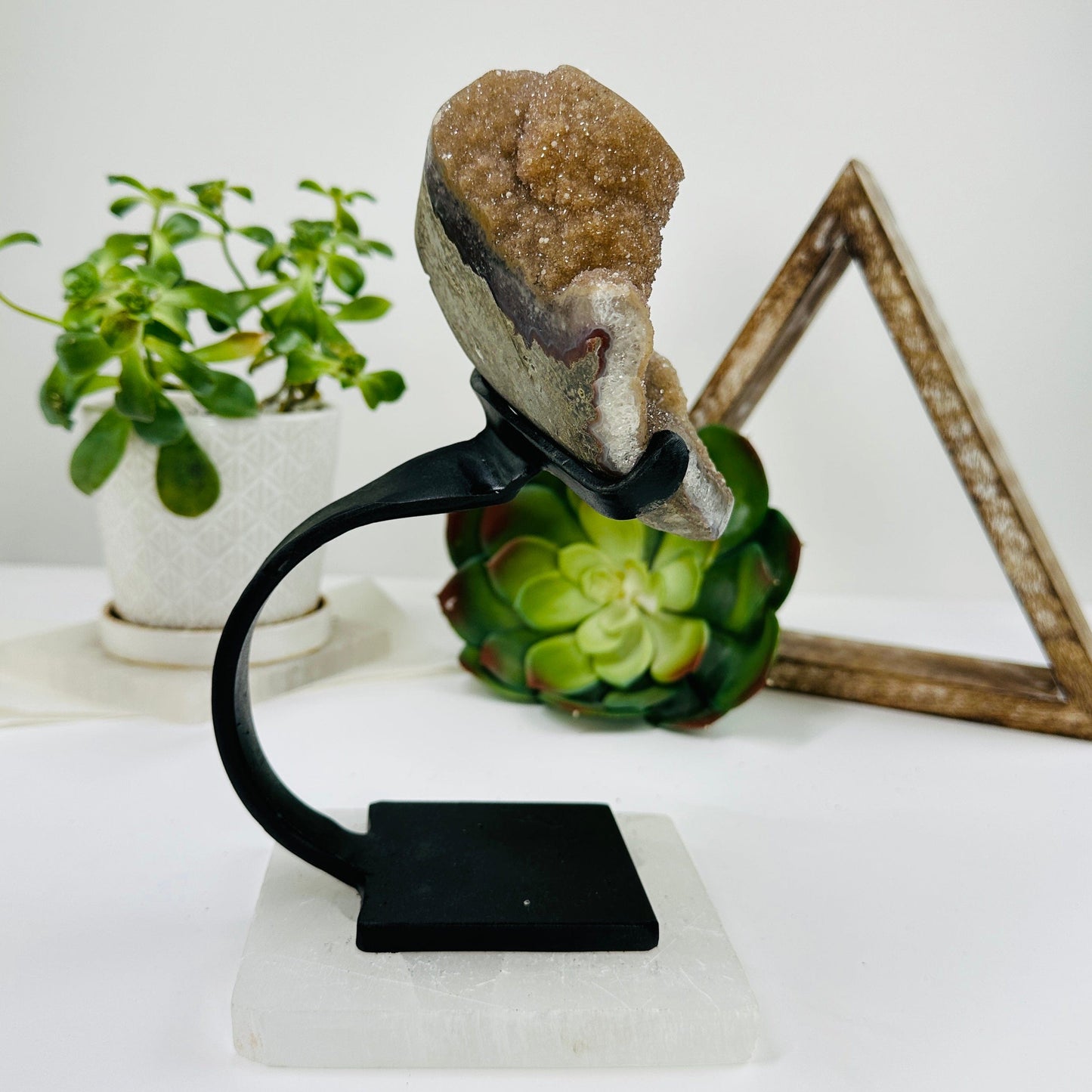 amethyst on metal stand with decorations in the background