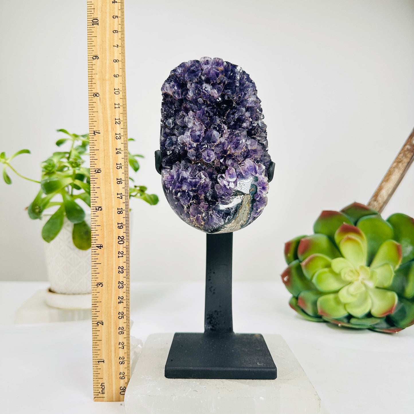 amethyst with stand next to a ruler for size reference