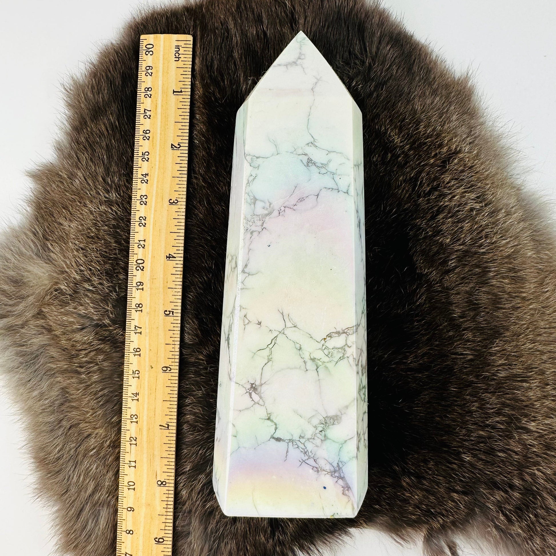white howlite aura tower next to a ruler for size reference