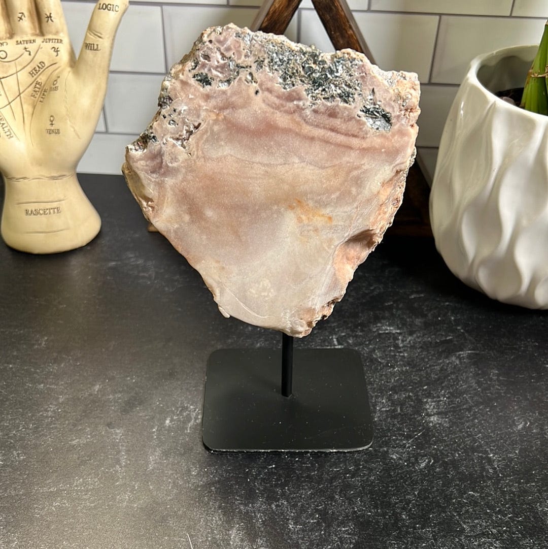 PInk amethyst slab on a black metal stand