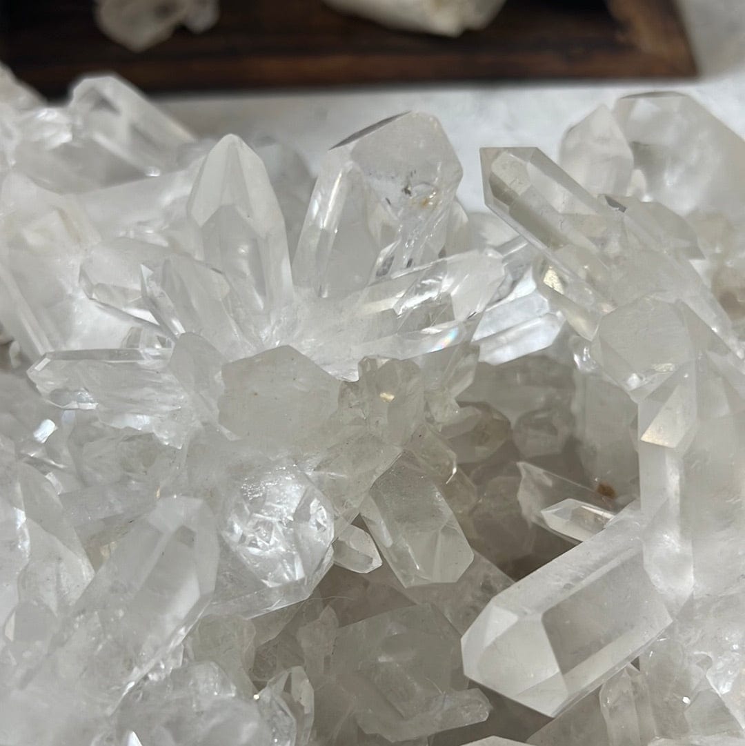 Close up of Large crystal cluster with points all over it on a cement background.