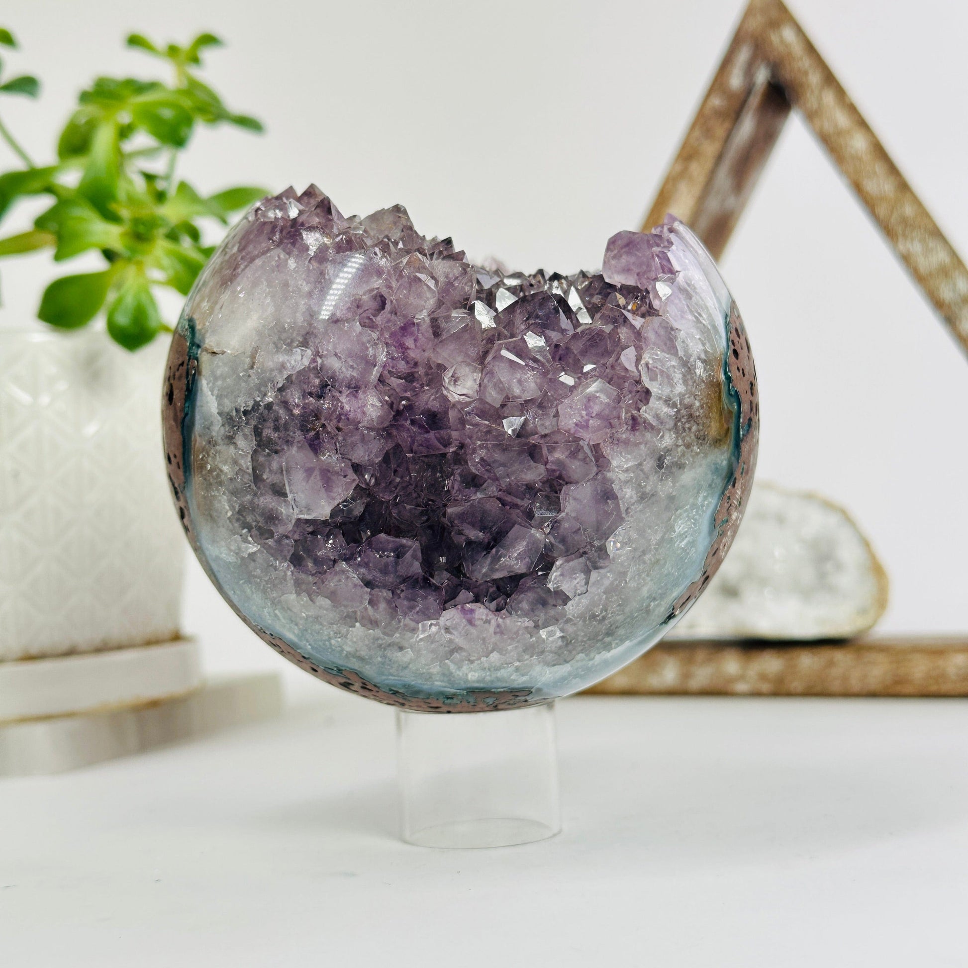 amethyst druzy sphere with decorations in the background
