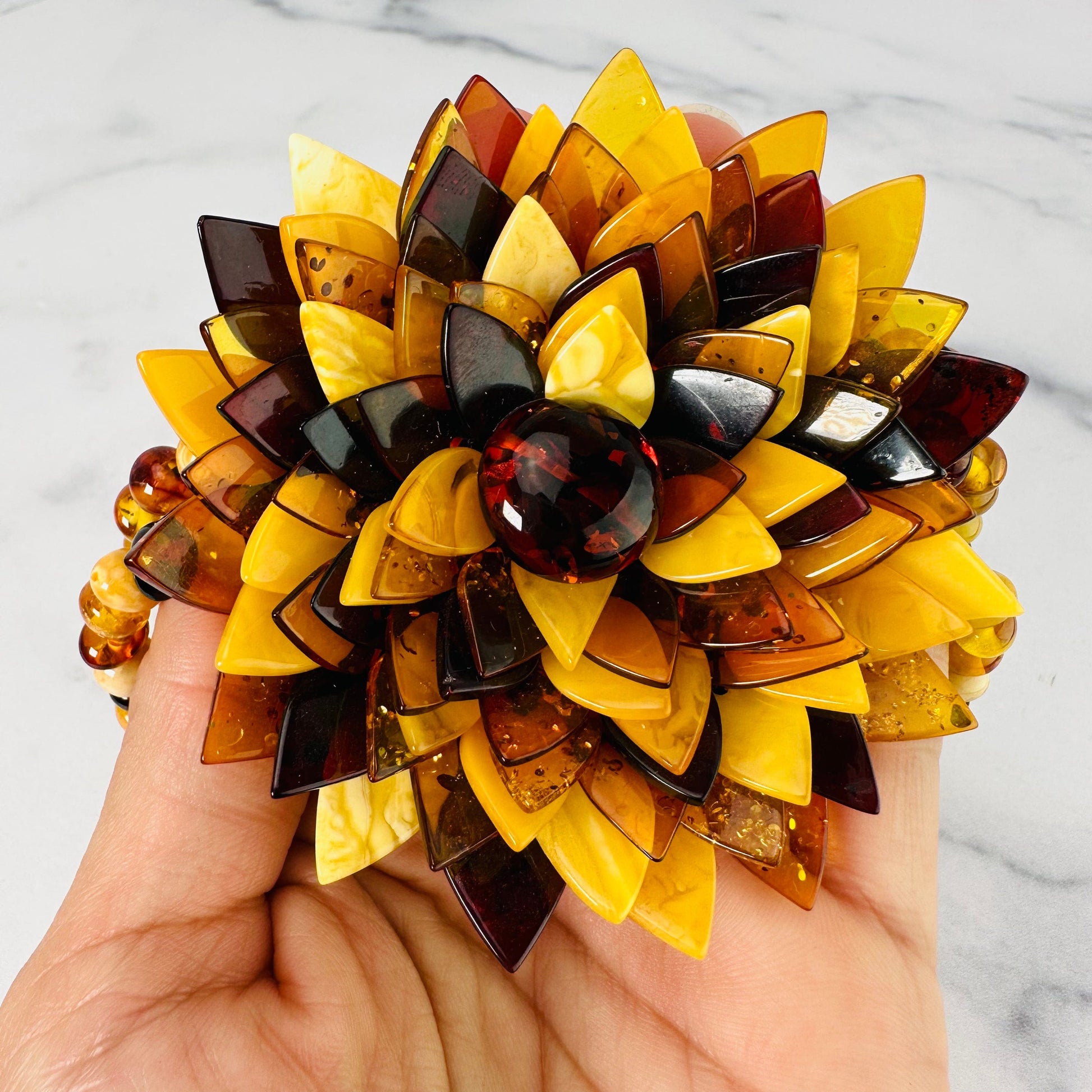 Up close view of multi-colored flower on the Baltic Amber Beaded Flower Necklace.